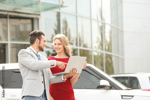 Salesman with laptop and cl...