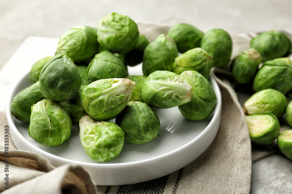 Plate with fresh raw Brussels sprouts on table Plate with fresh raw Brussels sprouts on table