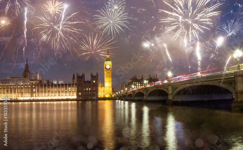 explosive fireworks display fills the sky around Big Ben. New Year's Eve celebration in the city © Melinda Nagy