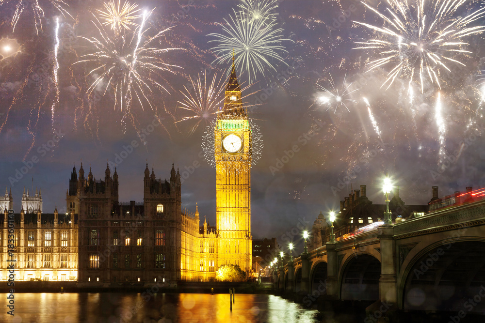 Fototapeta premium explosive fireworks display fills the sky around Big Ben. New Year's Eve celebration in the city
