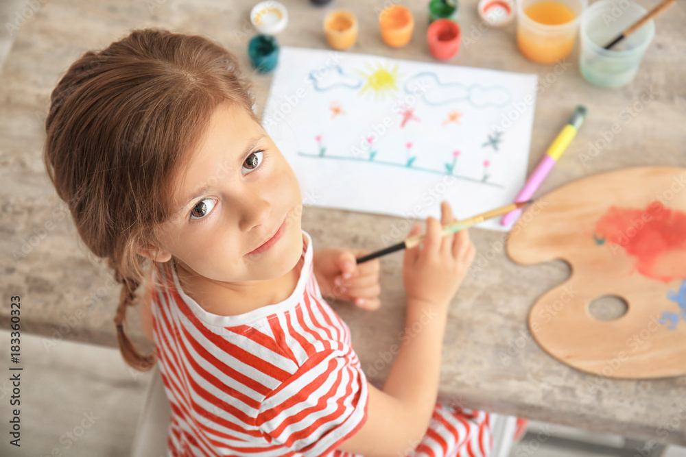 Little girl painting at table Little girl painting at table