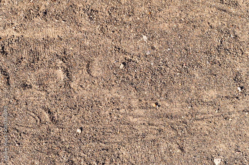 sandy path road with boot tracks. background, texture.
