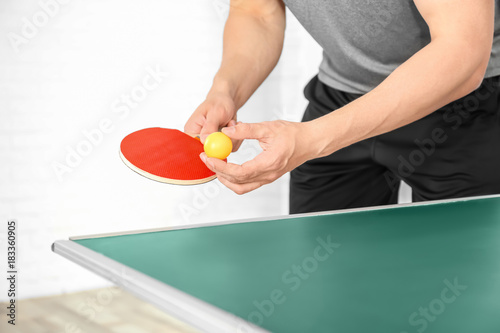 Man playing table tennis indoors