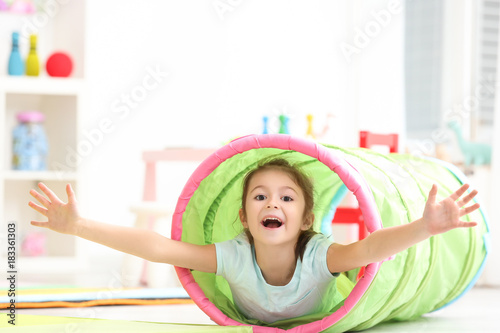 Cute little girl playing in...