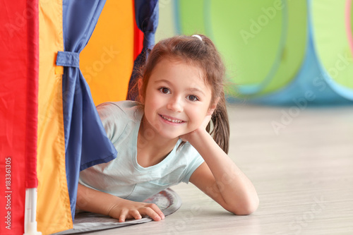 Cute little girl playing in...