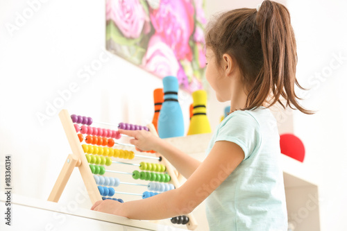 Cute little girl playing wi...