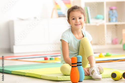 Cute little girl playing in...