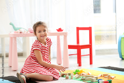 Cute little girl playing wi...
