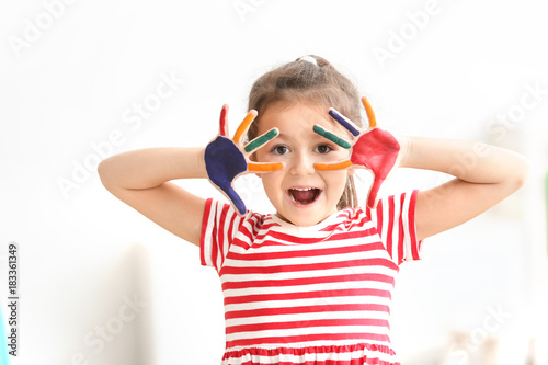Cute little girl with paint...