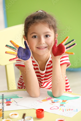 Cute little girl with paint...