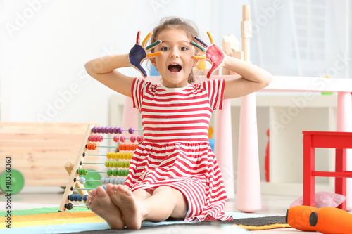 Cute little girl with paint...