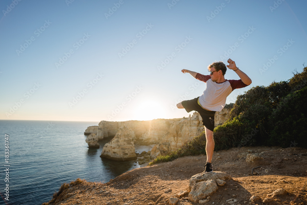 Kicks at sunset on a cliff in Portugal Kicks at sunset on a cliff in Portugal