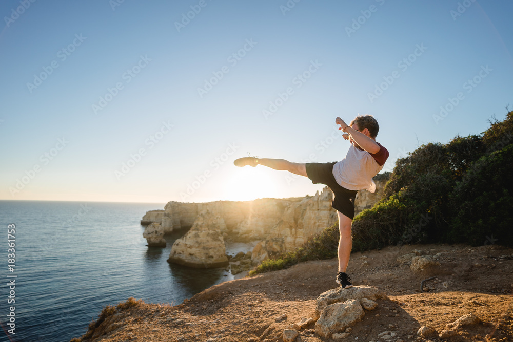 Kicks at sunset on a cliff in Portugal Kicks at sunset on a cliff in Portugal