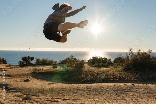 Man jumping on the cliff in Portugal