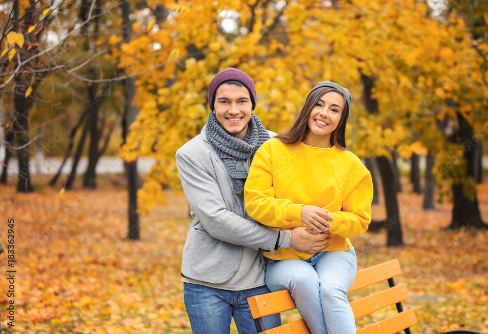 Young couple in park on autumn day Young couple in park on autumn day