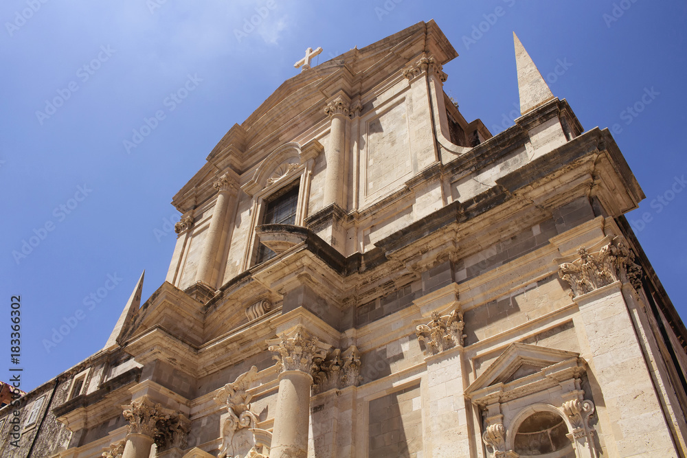 Fototapeta premium Bottom view of Saint Ignatius Church in Dubrovnik old town with clear blue sky background.