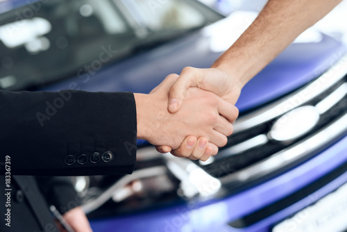 Two men shake hands, making a deal.