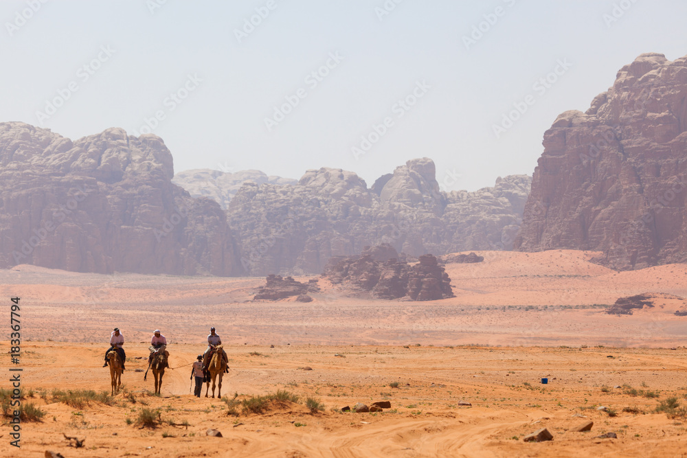 Travellers explore the desert in Wadi Rum, Jordan