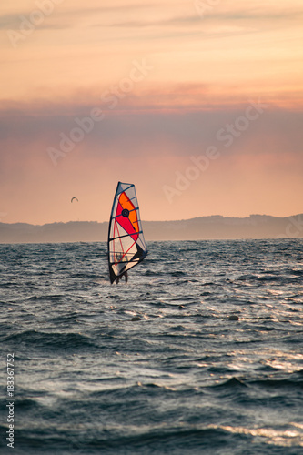 Sunset over the sea or ocean and extreme freestyle sport windsurfing © barmalini