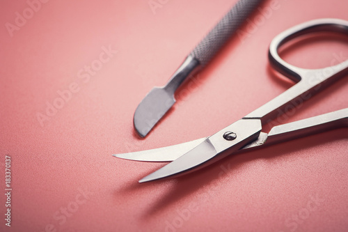 Cosmetic scissors on pink