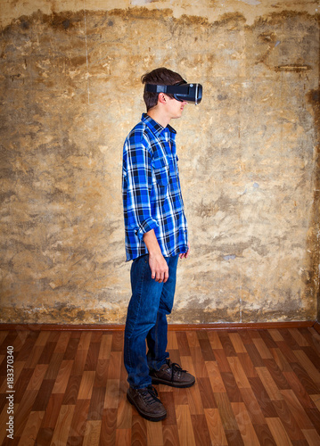 Young Man in VR Glasses © Sabphoto