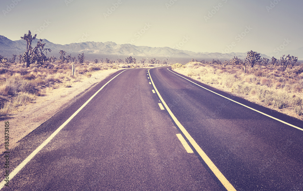 Deserted highway, retro color toned picture, travel concept, USA.