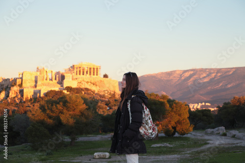 Young girl near fair sunset acropolis.Student in Athens,Greece.