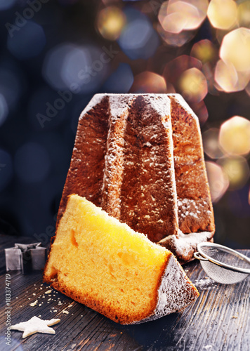 Pandoro -typical Italian christmas sweet yeast bread on old rustic wooden table. With free text space. photo
