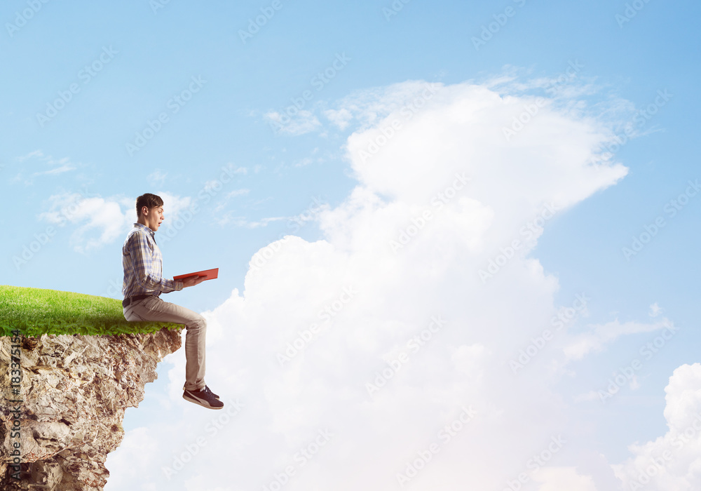 Student guy with book in hands preparing for exam Student guy with book in hands preparing for exam