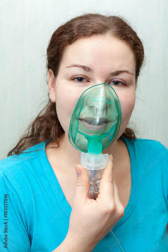 Catch cold woman with sore throat making inhalation itself with a mask on  her face. Nebulizer device Stock Photo | Adobe Stock