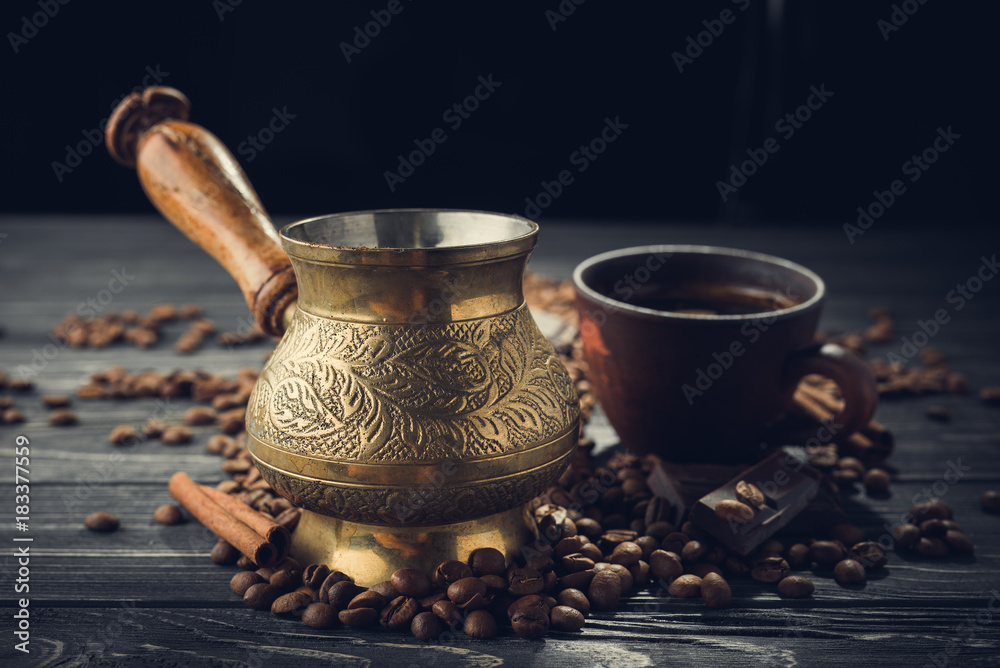 Old coffee cup and turk with roasted beans Old coffee cup and turk with roasted beans