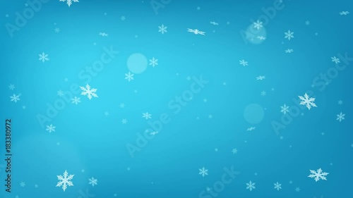 Beautiful light blue loopable abstract winter snow background with falling snowflakes and floating blurry glitter particles lights. 4K seamless loop video footage of the snowfall.