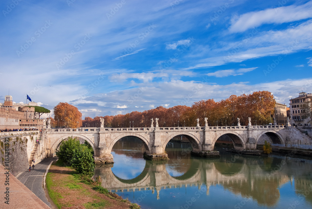 Ancient Ponte Sant'Angelo (Holy Angel Bridge) autumn or winter view with reflection on River Tiber in Rome