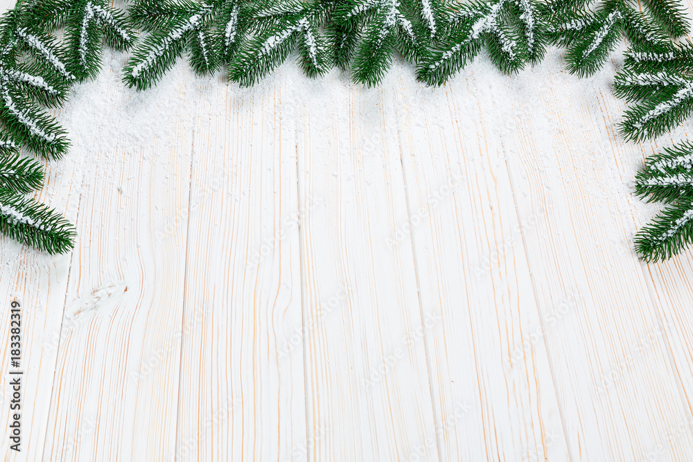 Christmas fir tree with snow on white wooden background. Free space frame Christmas fir tree with snow on white wooden background. Free space frame