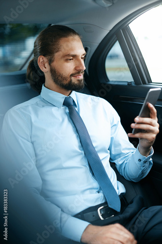 Young Successful Man Working On Phone Sitting In Car. © puhhha