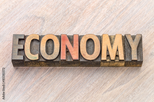 economy word abstract in wood type