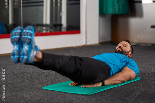 Fitness trainer doing abs crunches