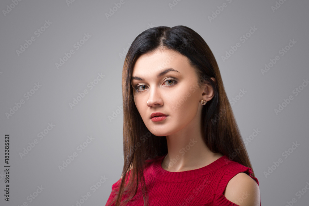 Pretty brunette woman in red dress on grey background. Pretty brunette woman in red dress on grey background.