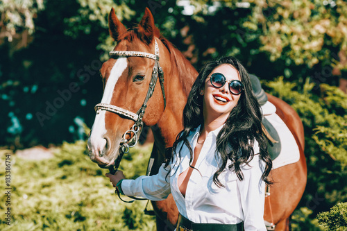 fashionable brunette with a racehorse