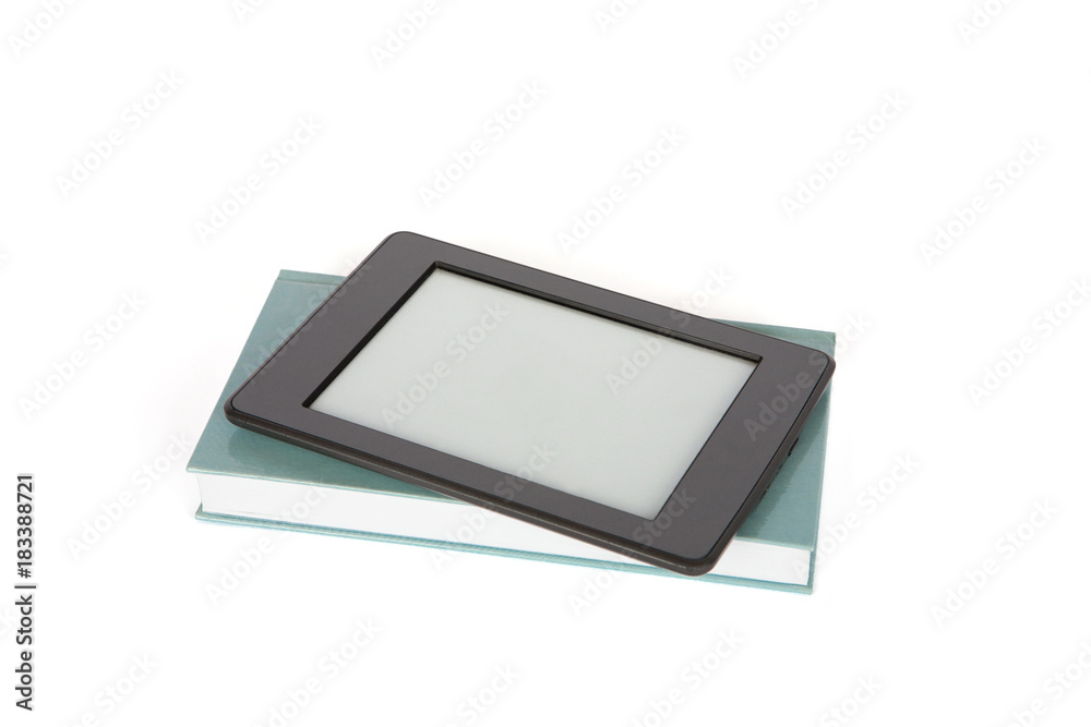 Ebook reader tablet with empty screen on top of a paper book. Isolated on white background Ebook reader tablet with empty screen on top of a paper book. Isolated on white background