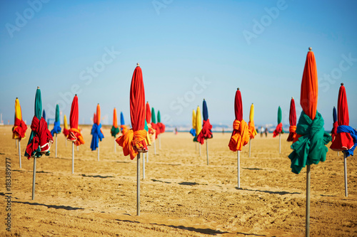 Many colorful umbrellas on the beach of Deauville