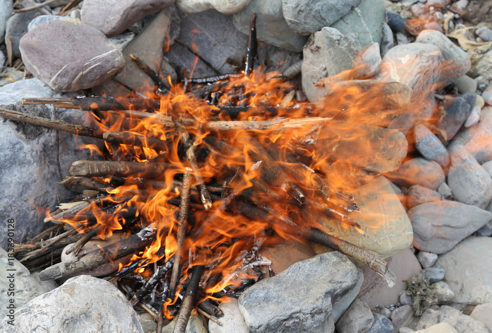 bonfire made with stones in a circle with a lively flame of fire