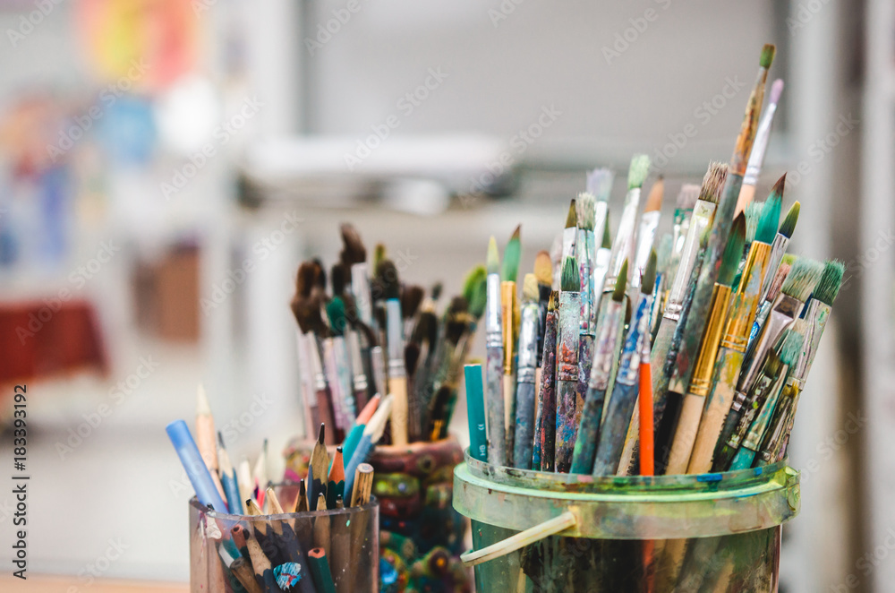 Set of artistic multicolor brushes in basket Set of artistic multicolor brushes in basket