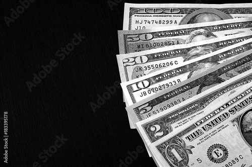 Us dollars on black board background black and white.