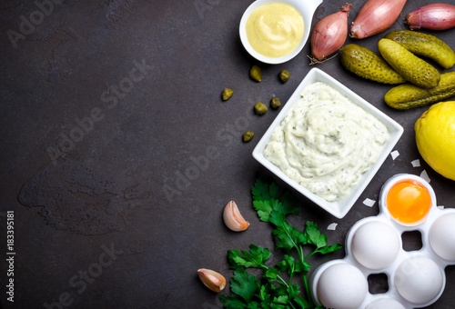 Traditional french sauce remoulade in a white bowl with ingredie photo