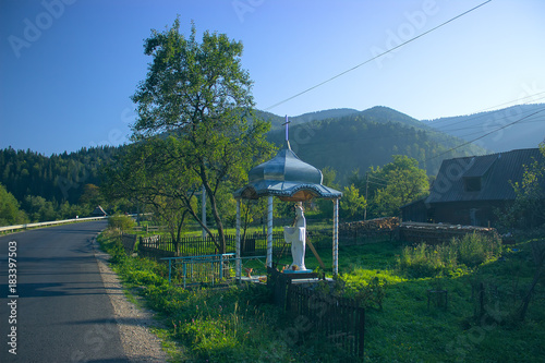 The silhouette of the cross and church bell tower in sunrise