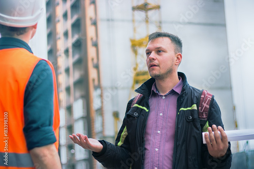man talking about problems at construction project to engineer.