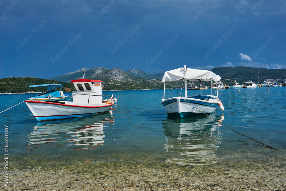 Fishing boats in the port on the island of Lefkada in Greece. Fishing boats in the port on the island of Lefkada in Greece.