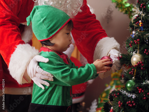 baby girl  decorating Christmas tree photo