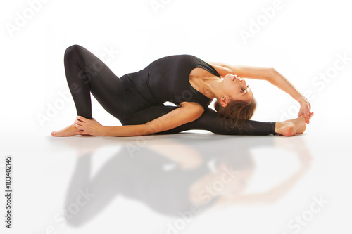 beautiful flexible woman doing yoga poses on white